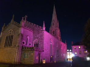 A church lit up by purple lights.