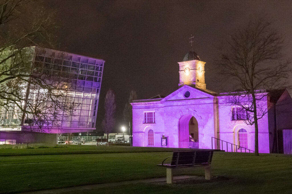 A building lit up with purple lights.