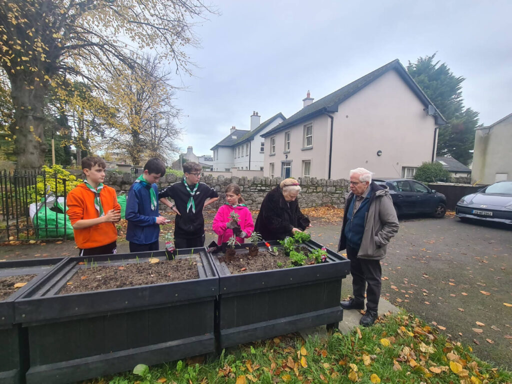 Group of people of all ages at the Intergenerational Gardening Project .